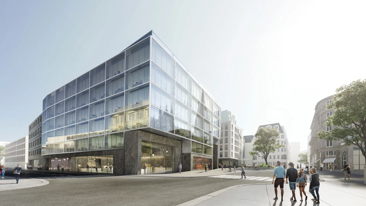 Modern glass-fronted office building on a city street; pedestrians walk along sidewalks and cross a crosswalk.