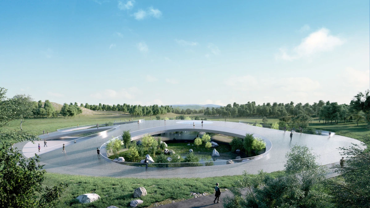 Circular elevated pedestrian loop around a central landscaped island in a park; people walk along the path.