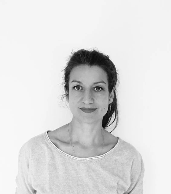 Portrait of an adult person facing the camera with a neutral expression against a plain white background.