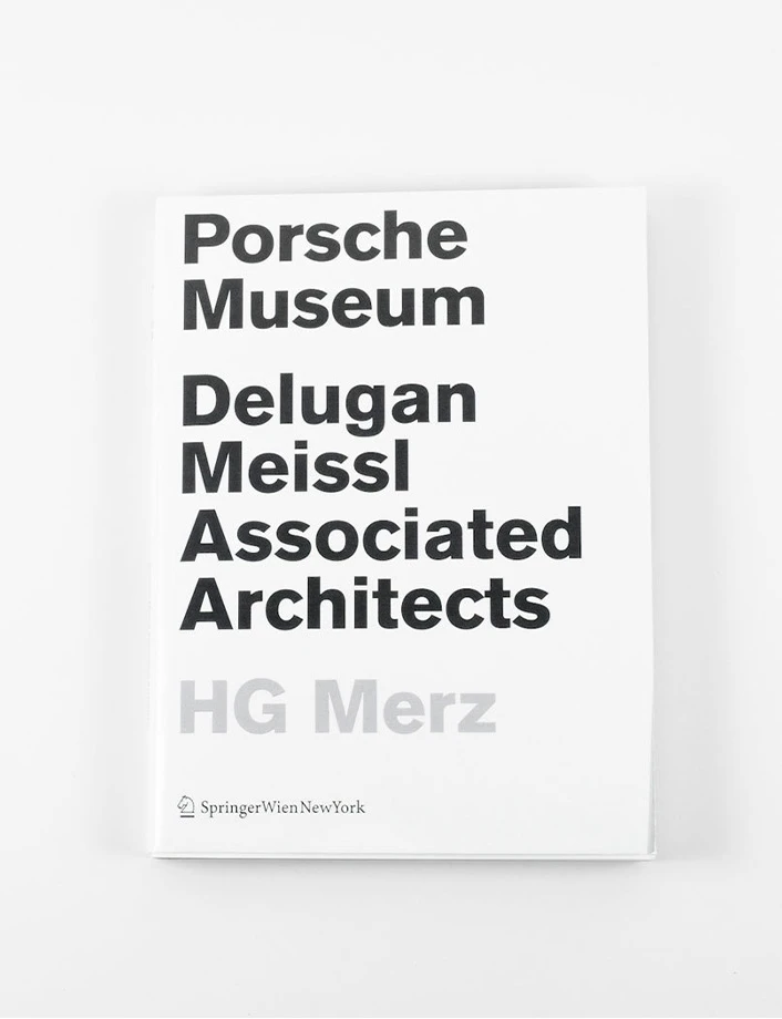 White book cover with bold black title: Porsche Museum Delugan Meissl Associated Architects; pale grey HG Merz at bottom.