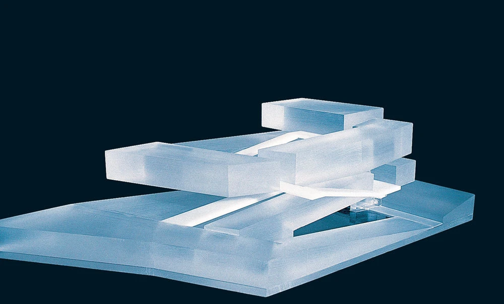 Translucent acrylic rectangular prisms stacked on a dark blue background.