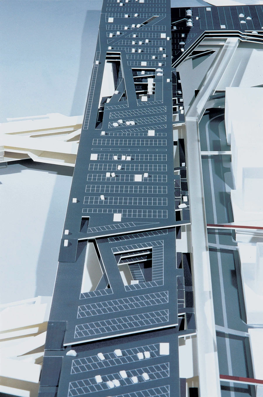 Blue steel beam assembly with grid perforations and triangular cutouts, forming a geometric interior structural element.