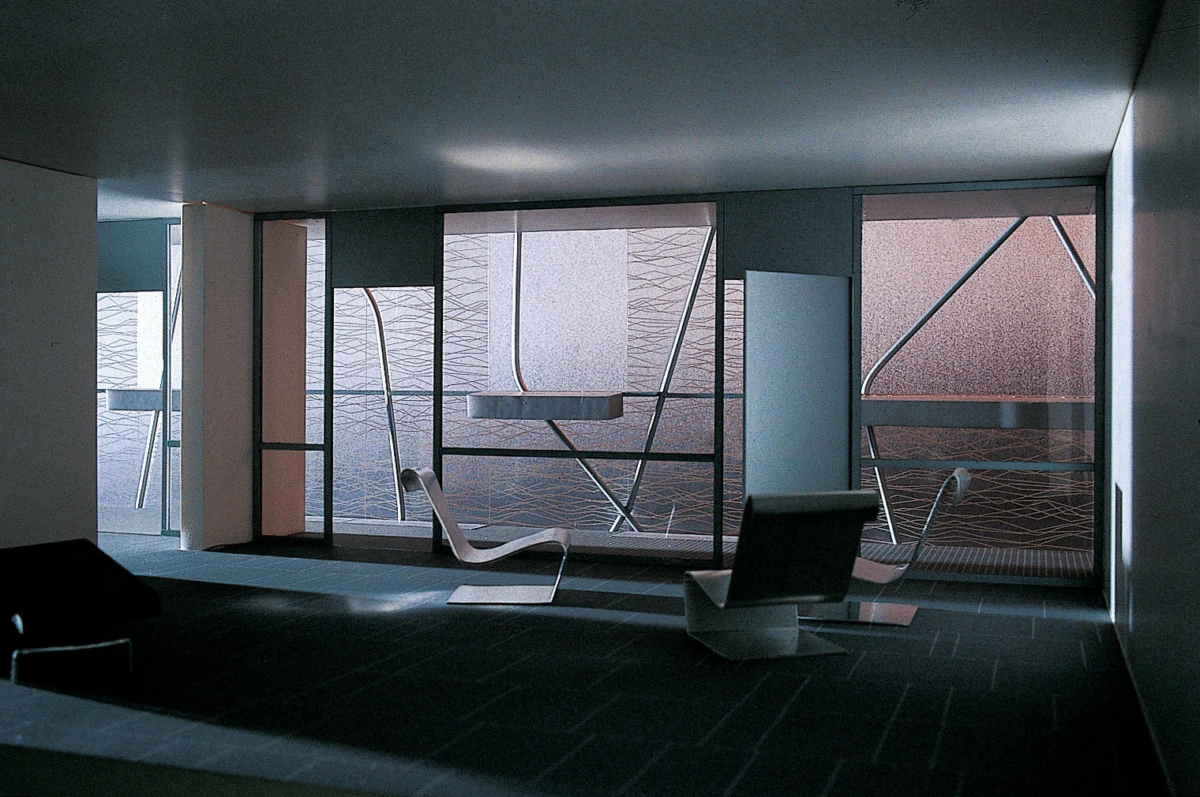 Empty modern living room with a white curved chaise and an angular lounge chair near frosted glass windows.