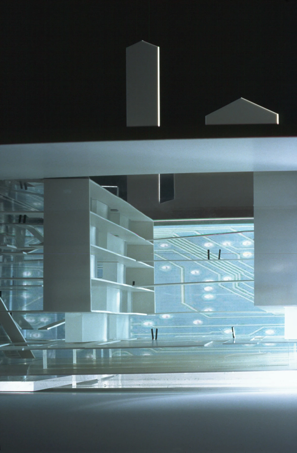 Futuristic, minimalist interior with white modular shelves and glass walls, set against a blue circuit-pattern backdrop.