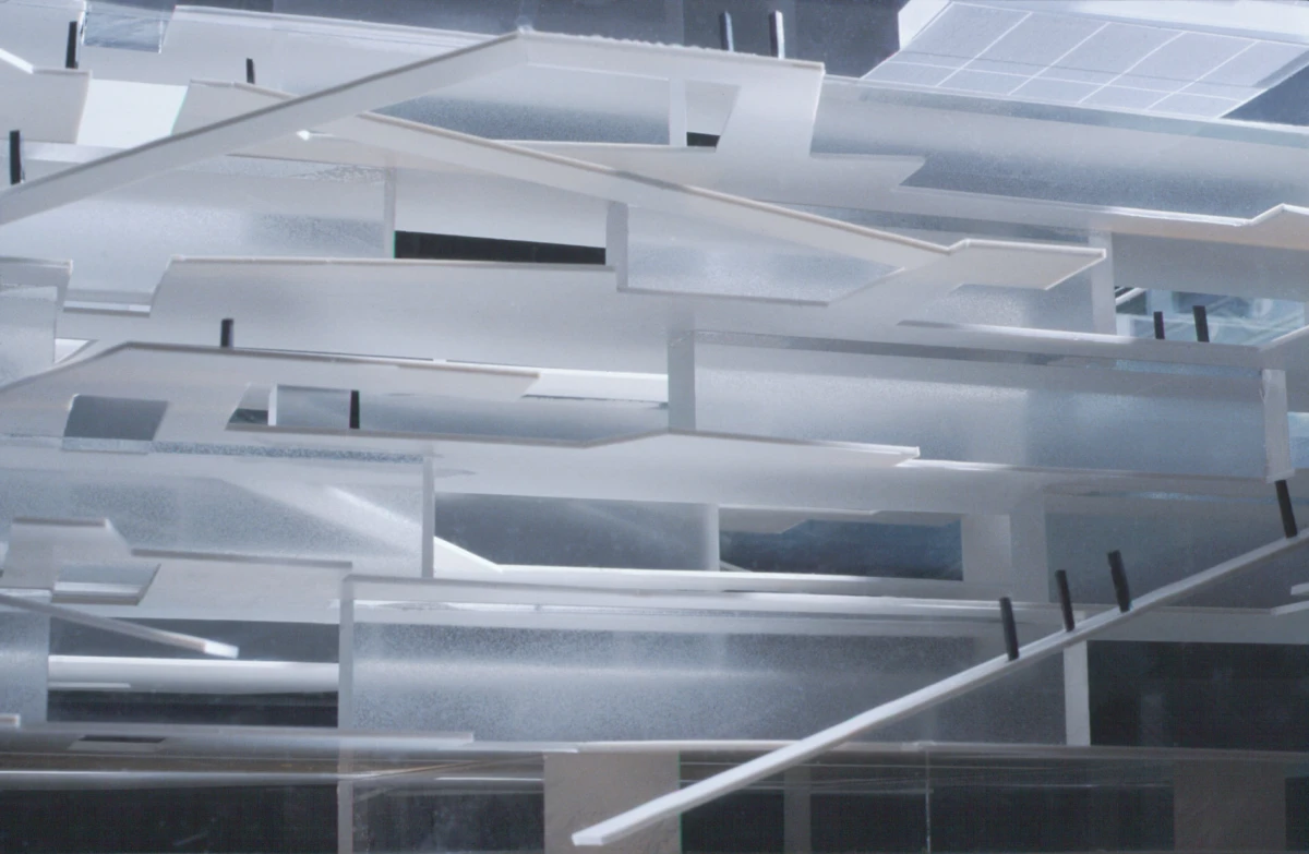 Geometric installation of overlapping translucent rectangular panels suspended in a bright modern interior.
