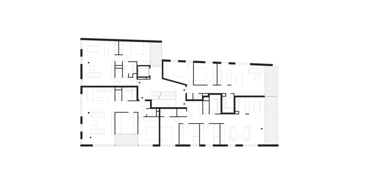 Floor plan of a multi-unit residential building, showing bedrooms, living areas, bathrooms, stairs, balconies, and corridors.