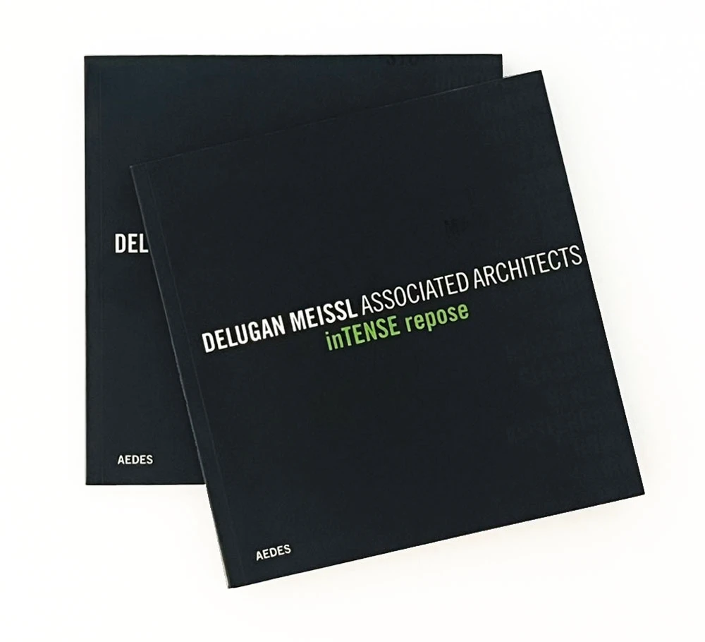 Two overlapping black architectural portfolio books on a light background, with white diagonal title text and a green subtitle.