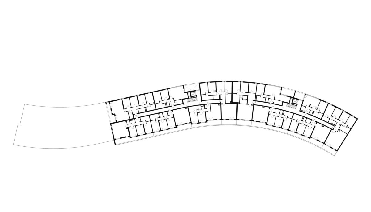 Curved architectural floor plan of a building wing, showing a long corridor flanked by many rectangular rooms and interior walls.