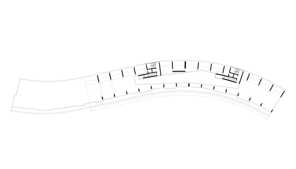 Curved architectural floor plan of a building wing, showing rooms and corridors.