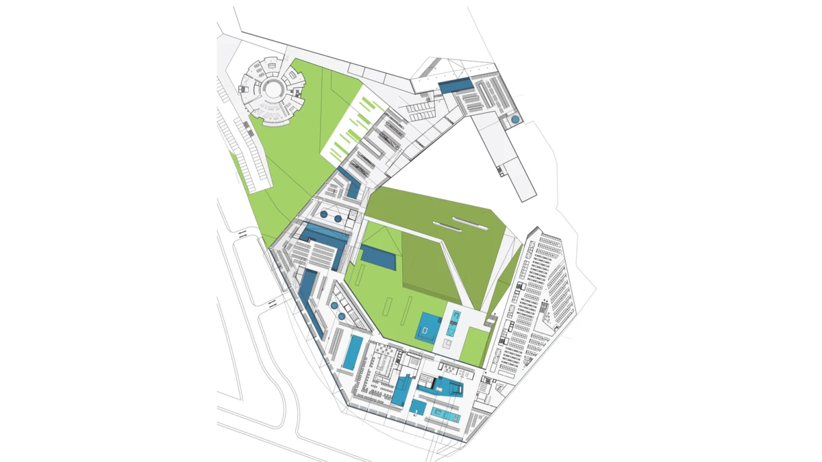 Top-down architectural site plan of a large complex with green lawns, blue buildings, and connecting walkways.