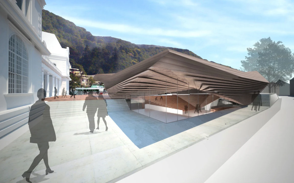 Modern brown, layered-roof pavilion with glass walls on a concrete plaza beside a white neoclassical building; silhouettes of people walking.