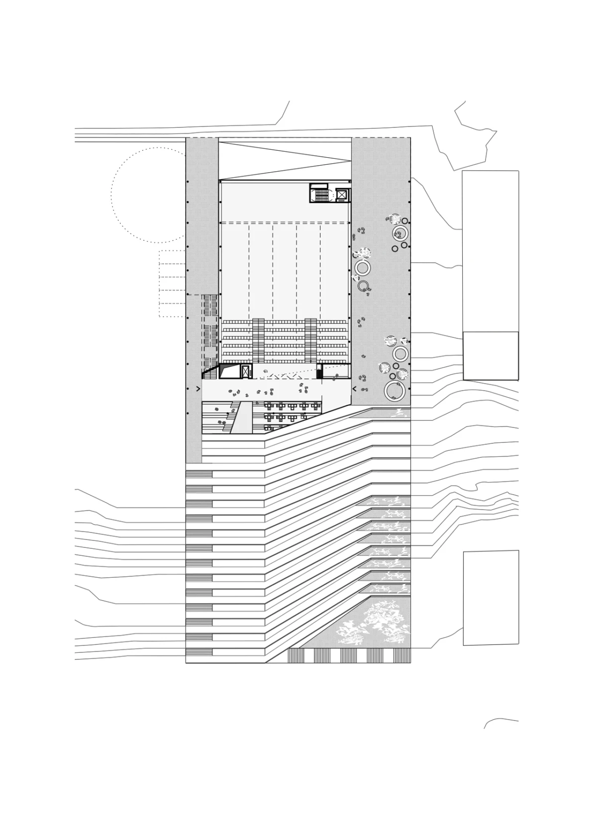 Architectural plan of a multi-level building with tiered seating in a central hall, set on a terraced hillside.