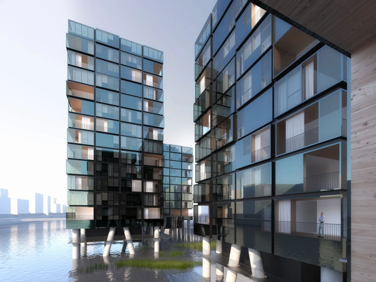 Glass-clad apartment buildings on stilts over water, with a person standing on a balcony of the rightmost structure.