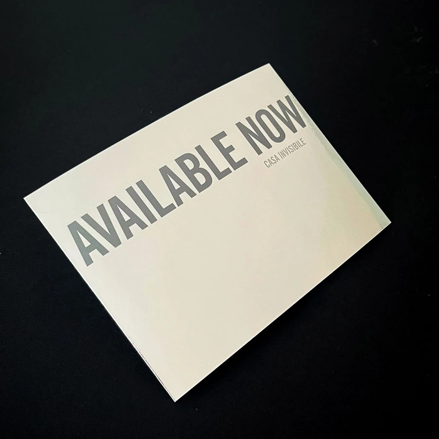 White rectangular card tilted on a black background with bold AVAILABLE NOW text.