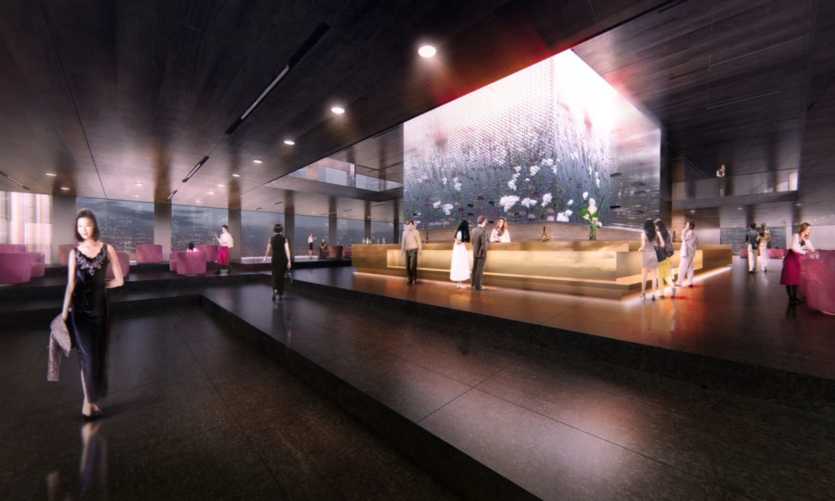 Person in a black evening gown walks through a luxury hotel lobby with a glowing front desk and a large digital screen.