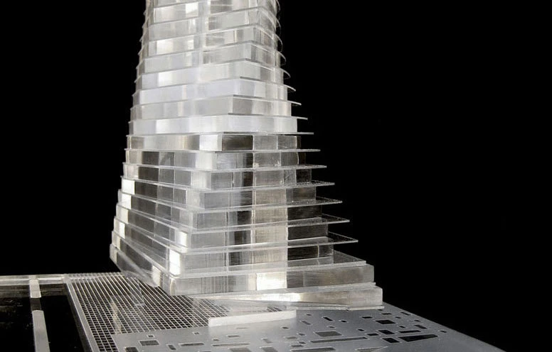 Tiered metallic skyscraper sculpture atop perforated metal base against black background.