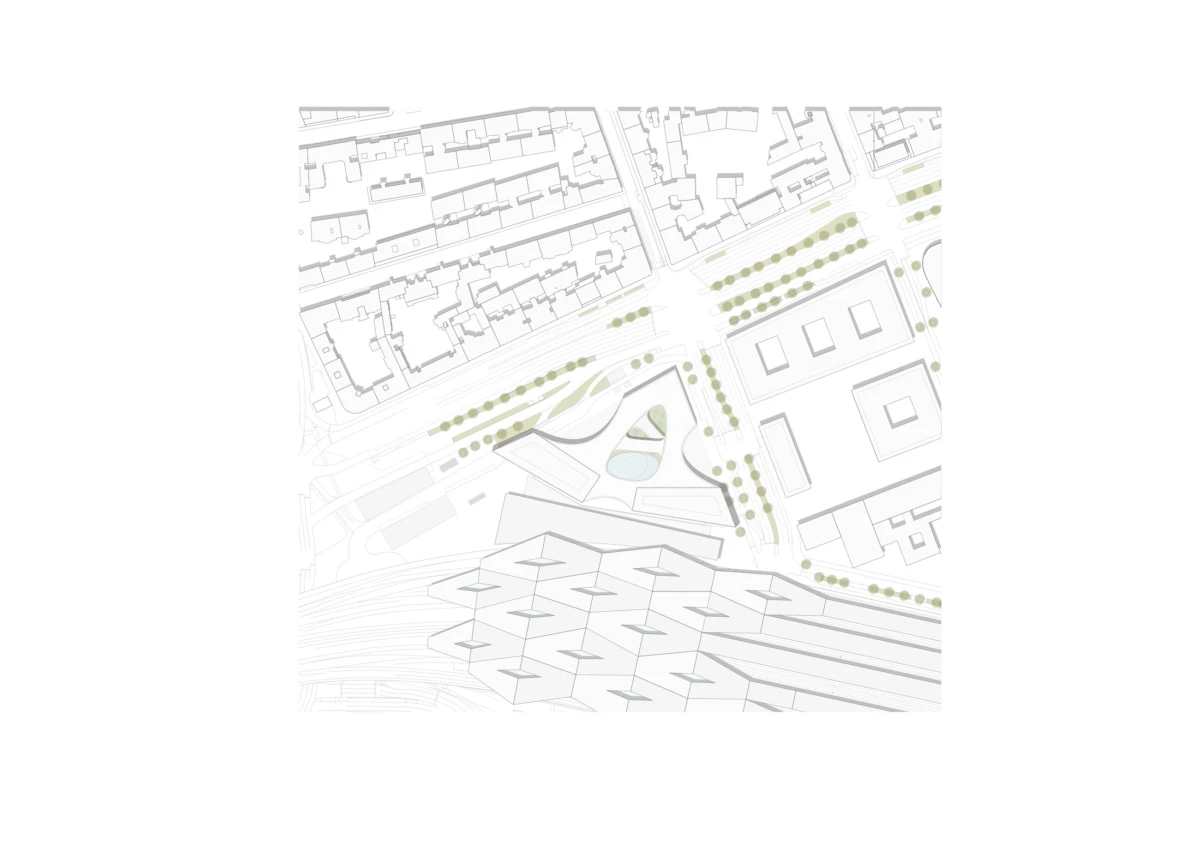Site plan of an urban development with building footprints, roads, tree-lined avenues, and a central landscaped plaza beside railway tracks.