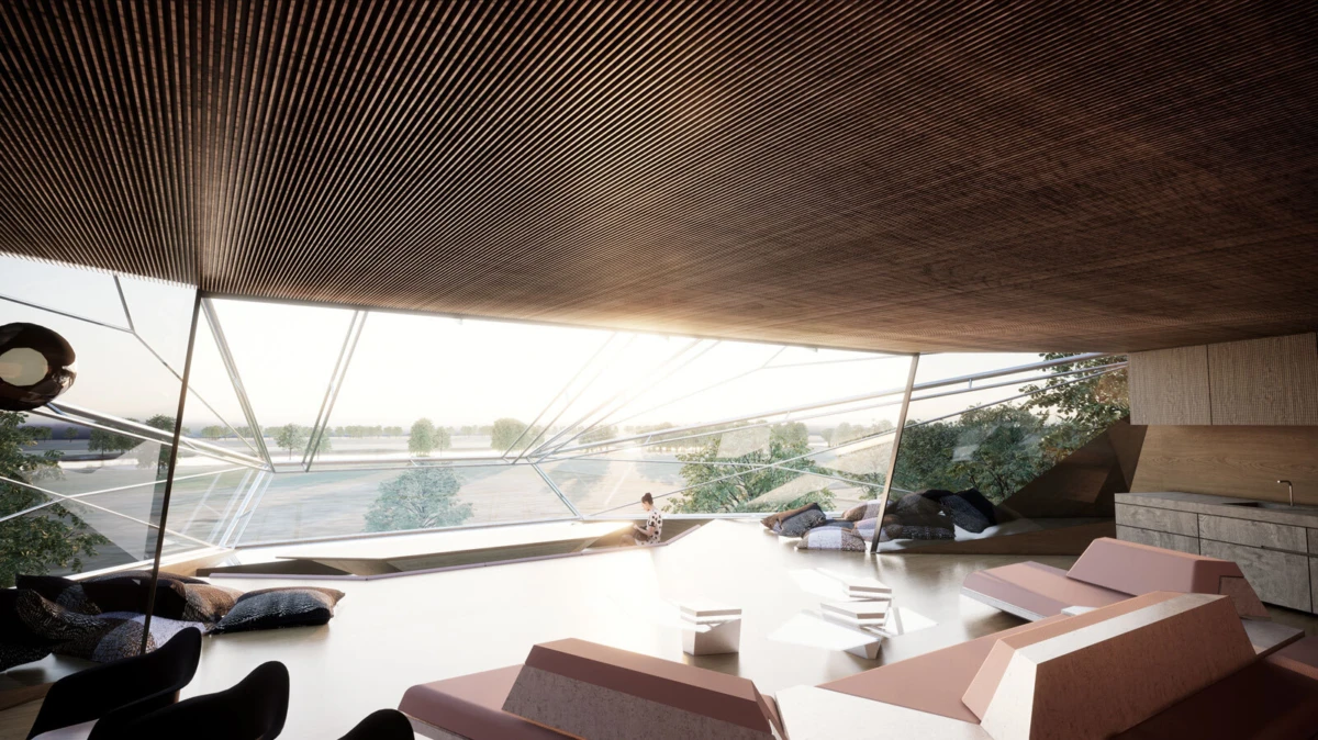 Person seated on a ledge in a modern lounge with floor-to-ceiling glass walls overlooking a river; geometric pink and white seating.