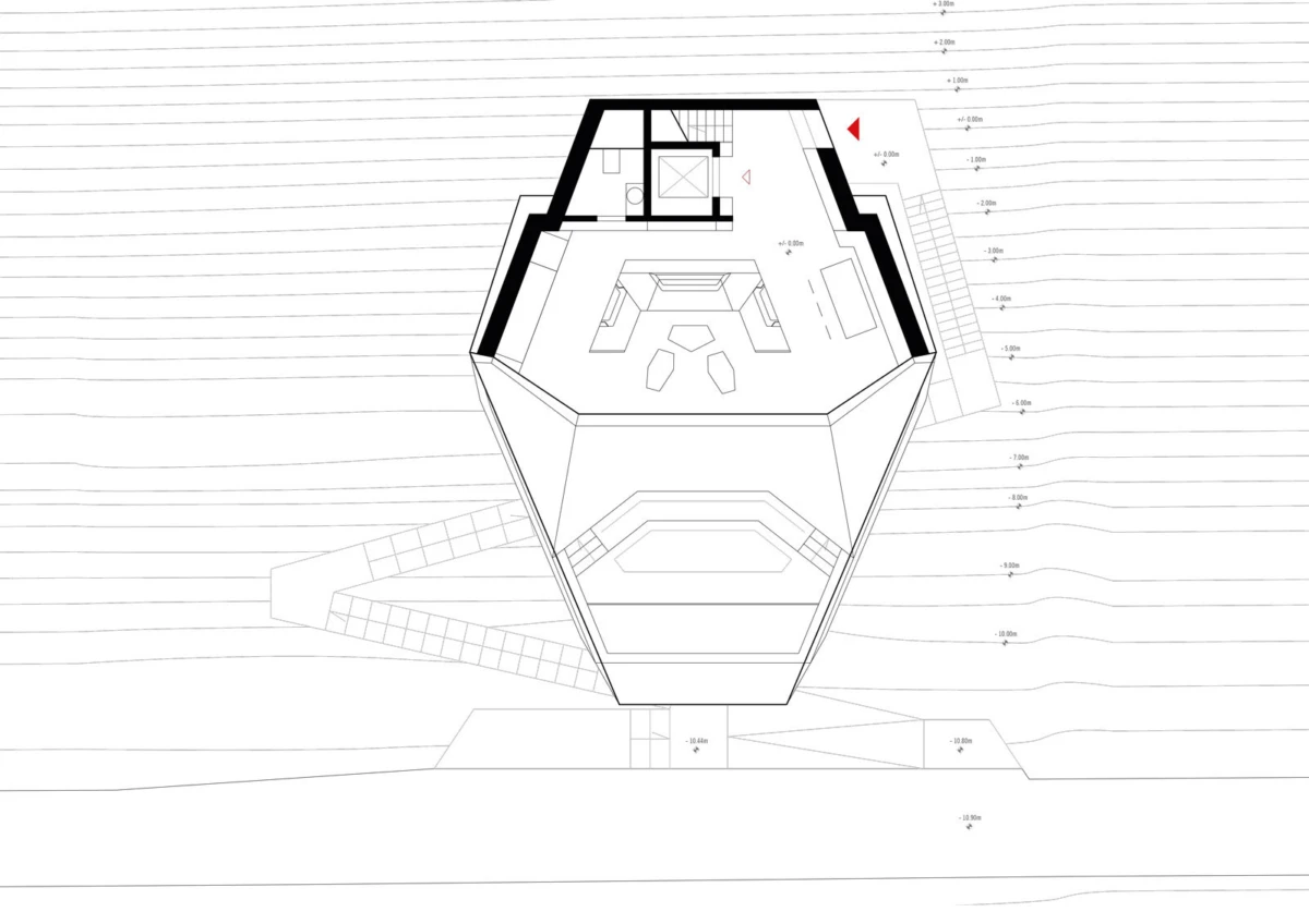 Top-down architectural floor plan of a polygonal tower interior, showing a living area with sofa and chairs, stairs, and surrounding contour lines.