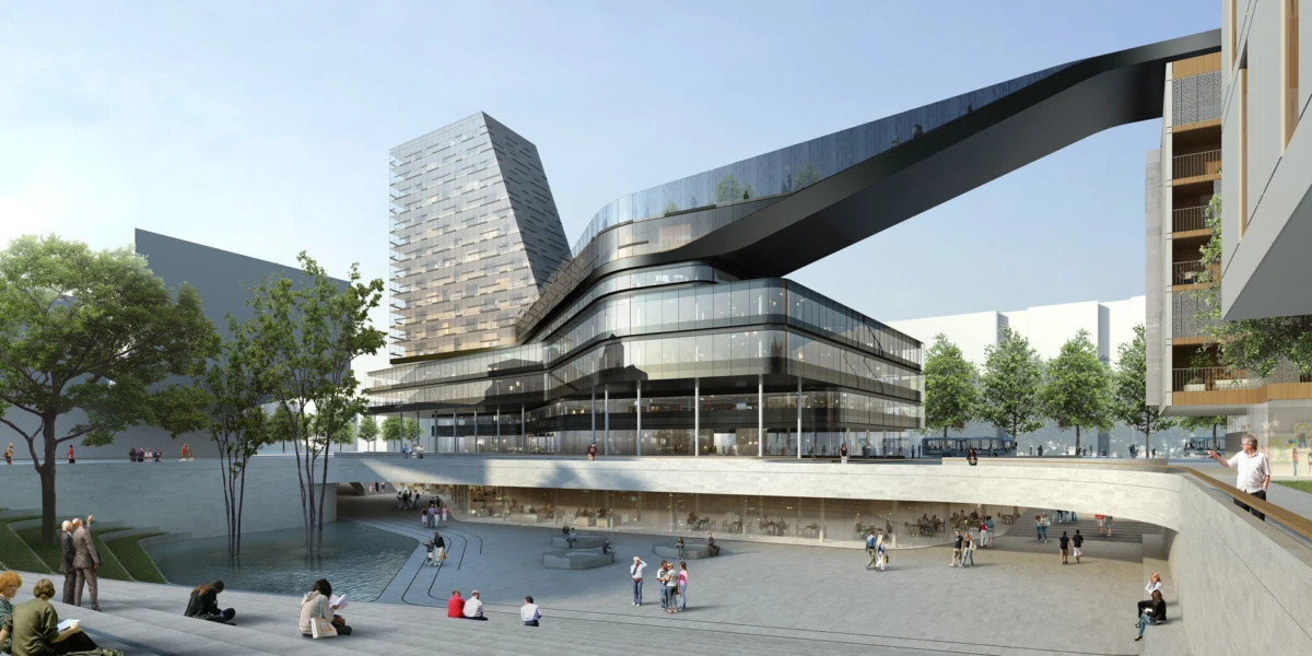 Futuristic glass-clad building with a sweeping skybridge over a public plaza; people stroll and sit by a water feature among trees.