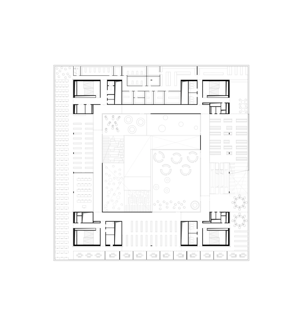 Architectural floor plan of a square building with a central courtyard, surrounded by rooms, corridors, and staircases.