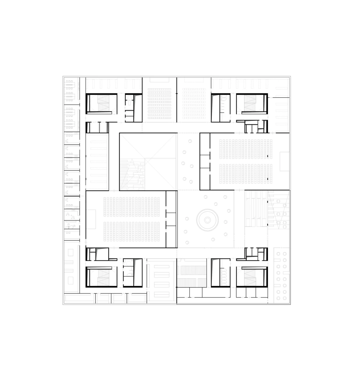 Architectural floor plan of a large square building; central circular atrium surrounded by auditoriums, classrooms, and corridors.