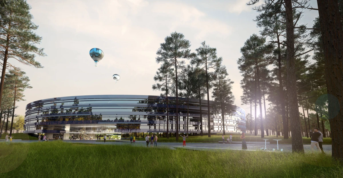Circular glass building in a pine forest park with people walking nearby as hot air balloons rise in the sky.