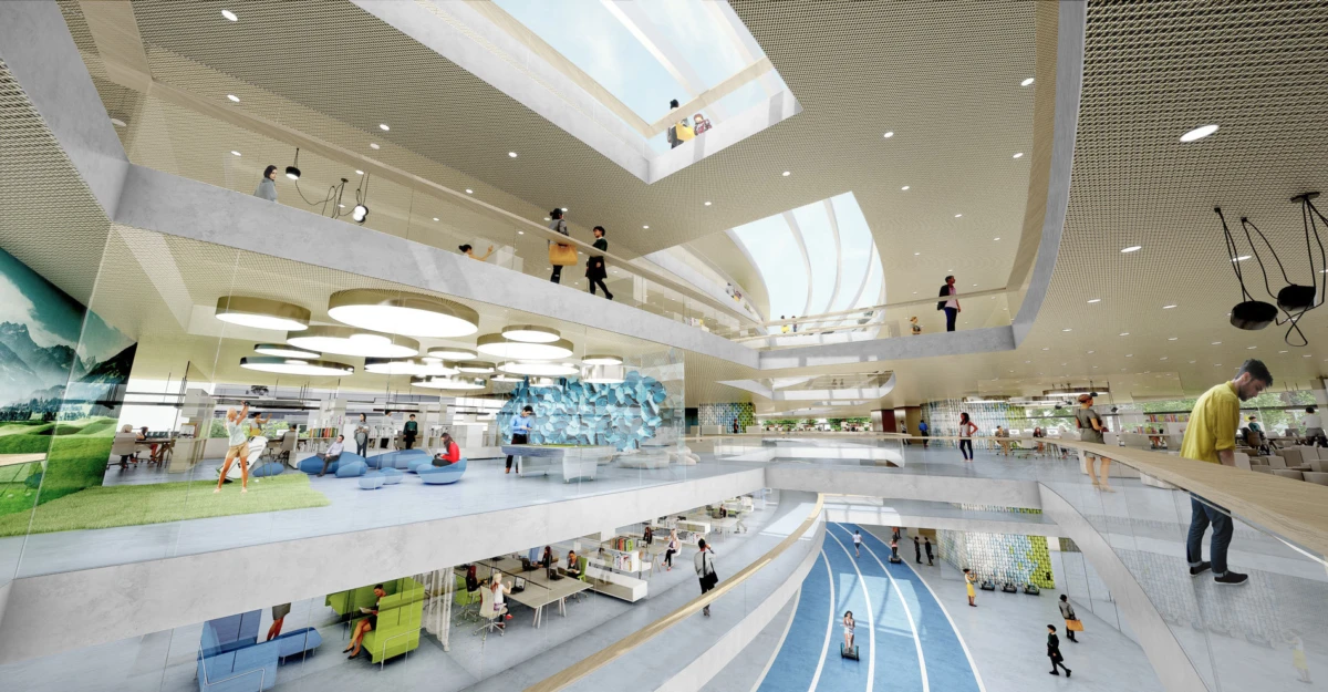 Open, multi-level atrium with curved white walkways, skylight, blue running track, and people walking, sitting, and conversing on each level.