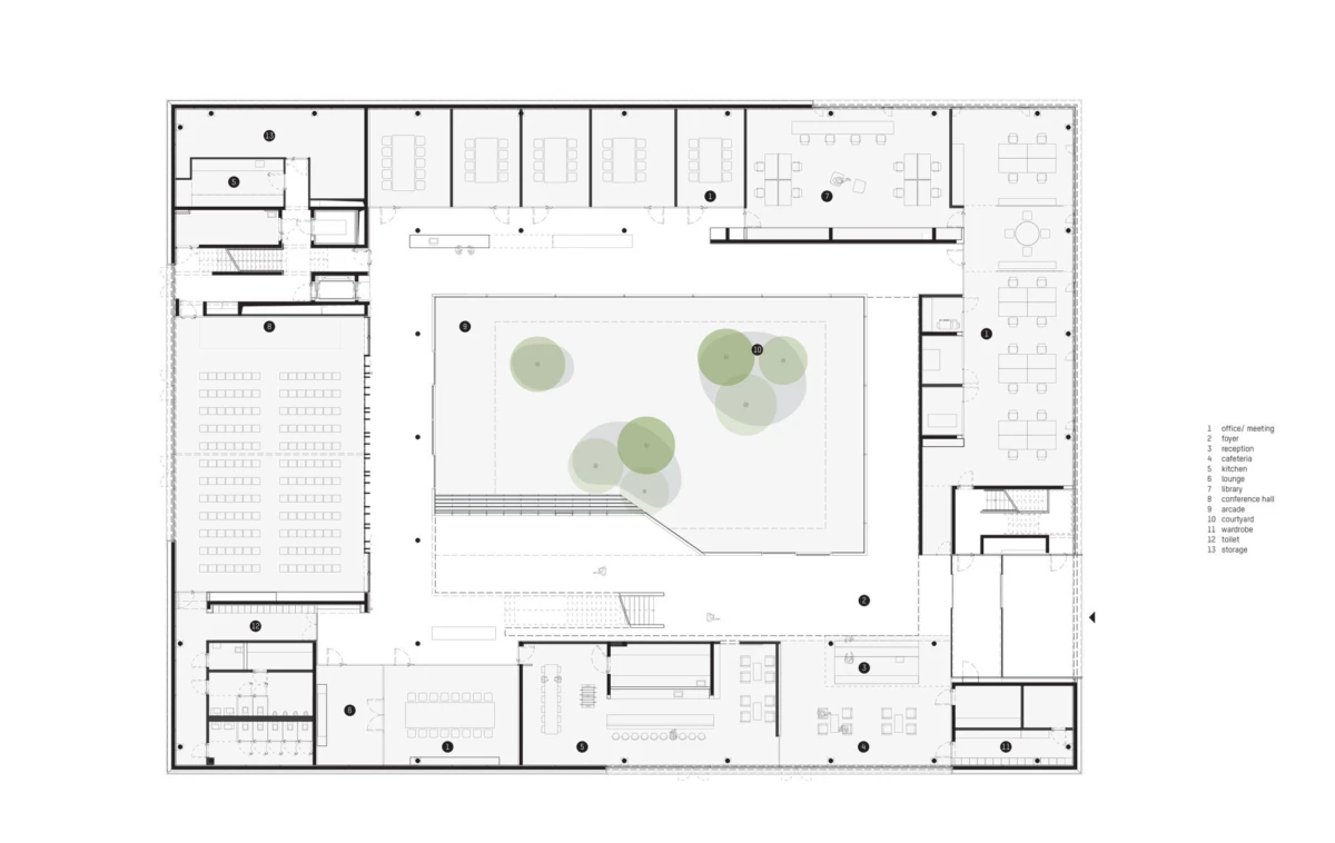 Architectural floor plan of a rectangular building surrounding a central courtyard with trees; multiple offices and rooms along the perimeter.