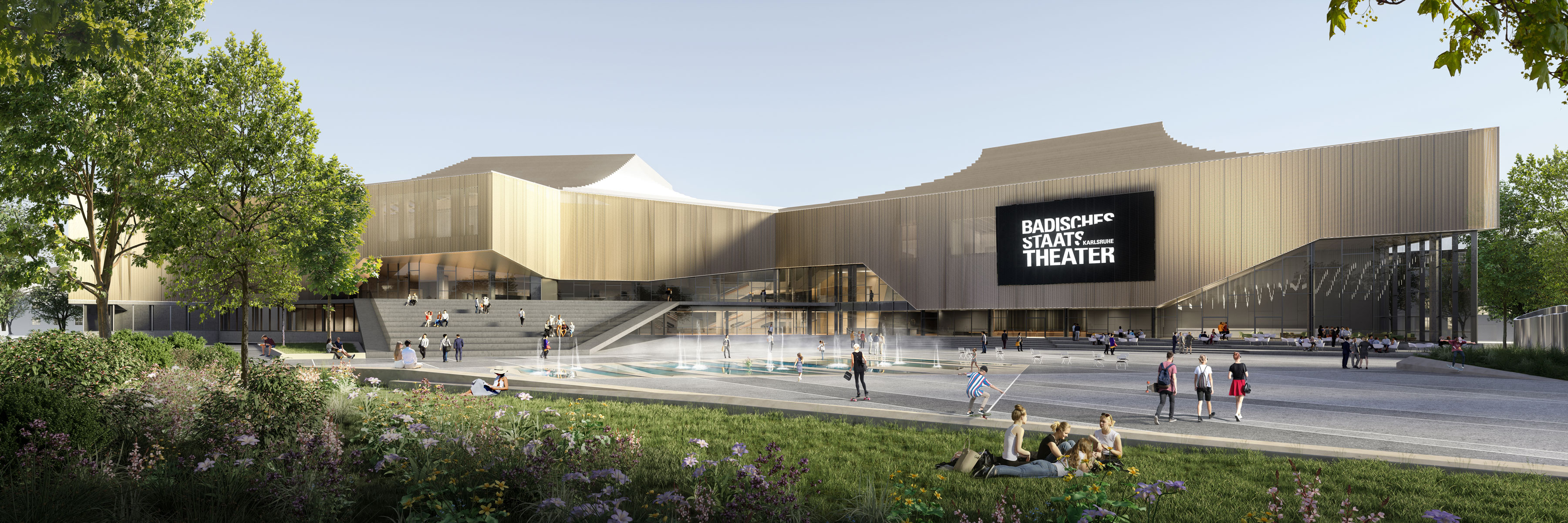 Modern theater building with a large black sign reading BADISCHES STAAT THEATER on the façade, in a plaza with steps, a water feature, and greenery.