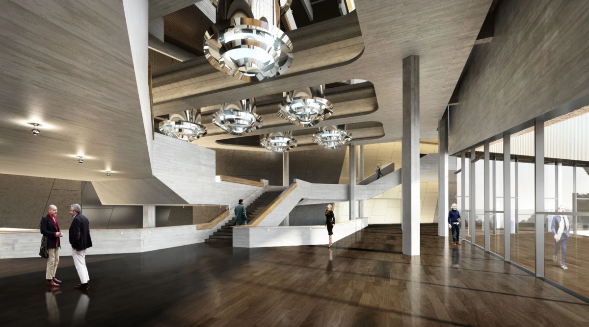 Contemporary concrete atrium with circular metallic chandeliers, a curved white staircase, and visitors walking on a dark wood floor.