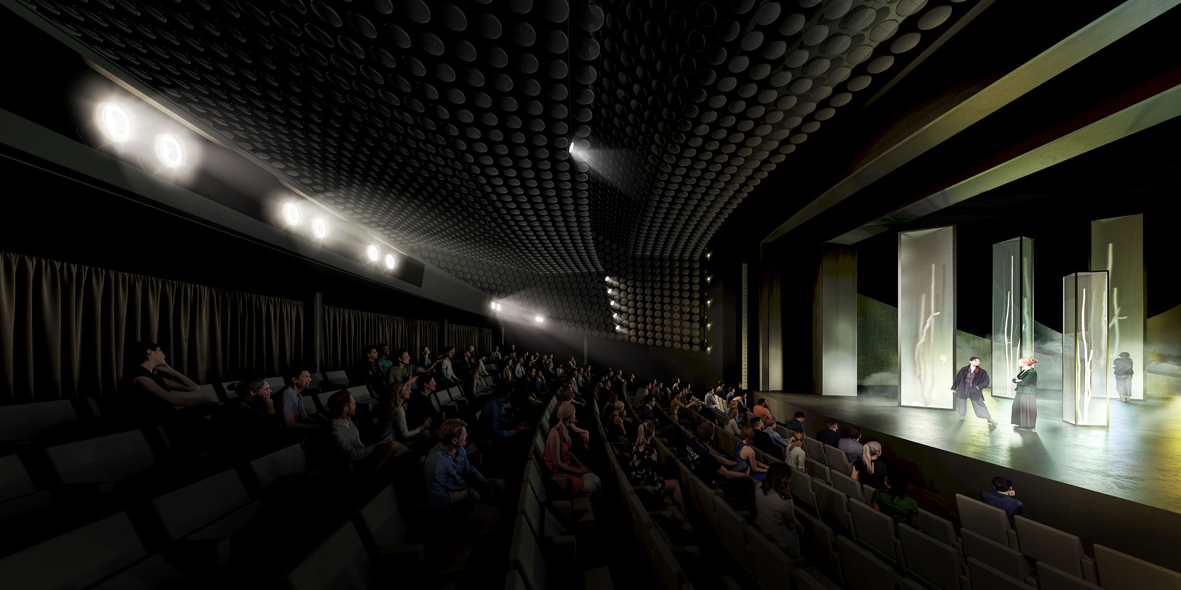 Audience seated in a dark theater watches a stage performance with two actors beside abstract glass panels under bright overhead lights.
