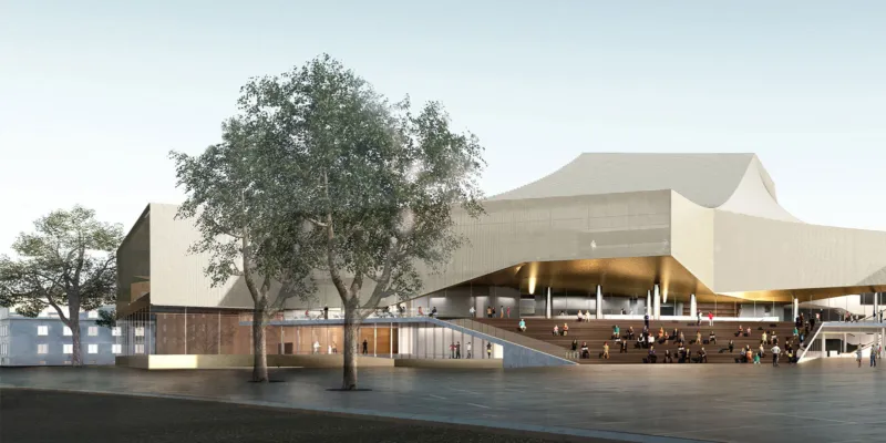 Modern cultural center with a broad stairway; people sit and walk on the open plaza under trees in front of the building.