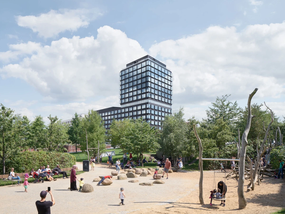 Public park with children playing on rocks; adults sit on benches as a modern glass office tower rises in the background.