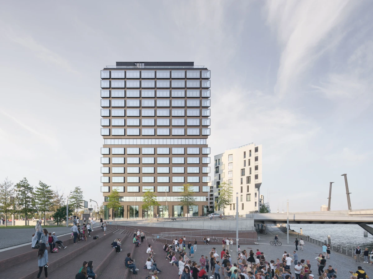 Glass-clad high-rise by a riverfront promenade; crowds sit on brick steps and stroll along the waterfront under a clear sky.