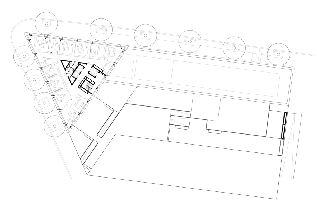 Architectural floor plan of a triangular-wing office building with interior offices and a tree-lined exterior boundary.