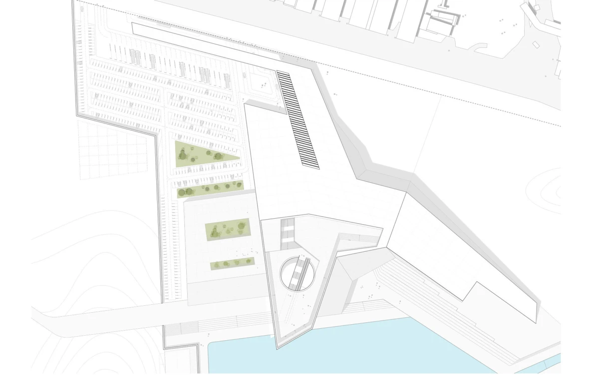 Aerial site plan of a modern architectural complex with angular white buildings, parking, landscaped strips, and a blue waterfront.