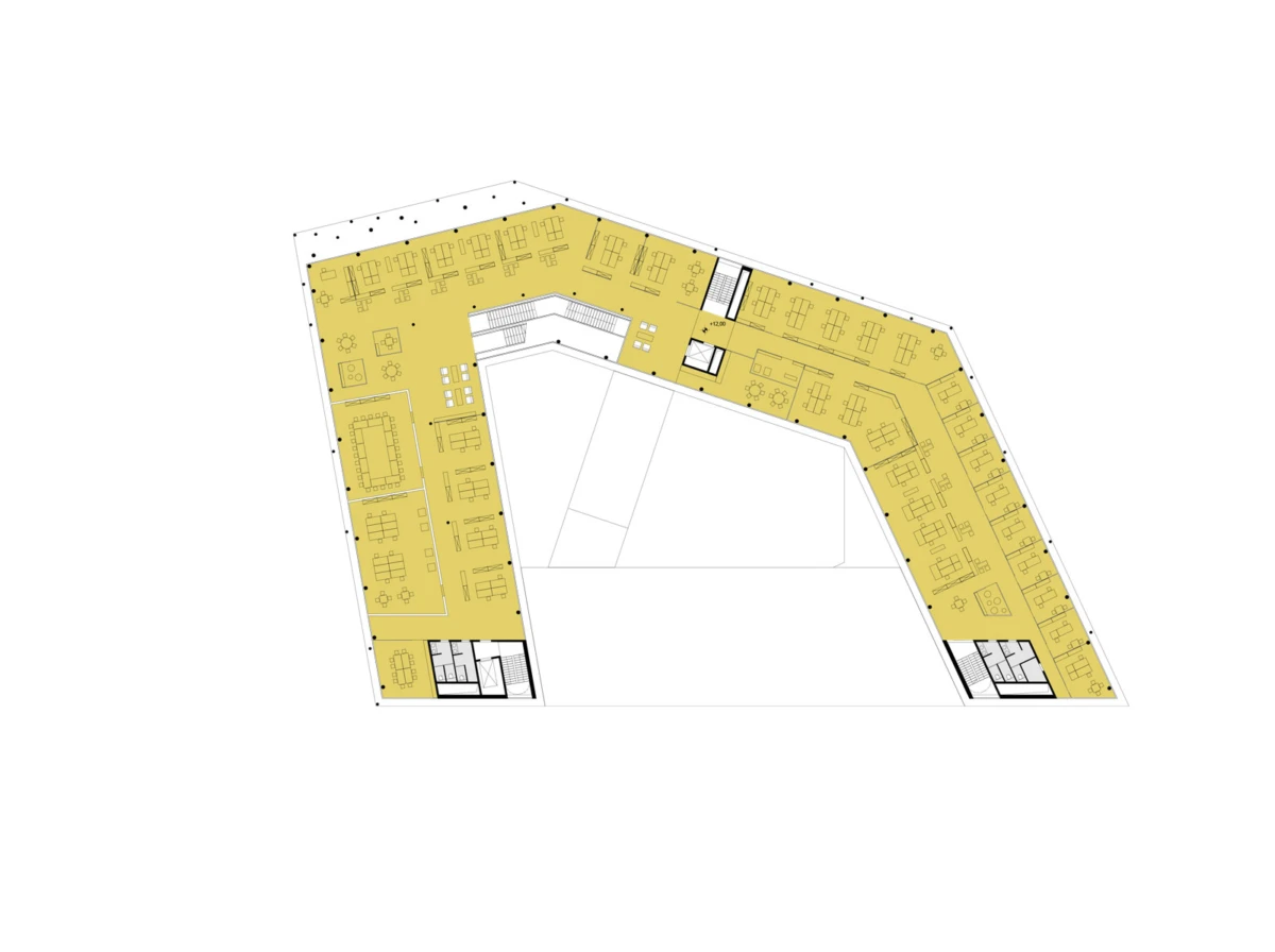 Architectural floor plan showing a U-shaped office layout with rows of workstations, meeting rooms, and corridors around a central void.