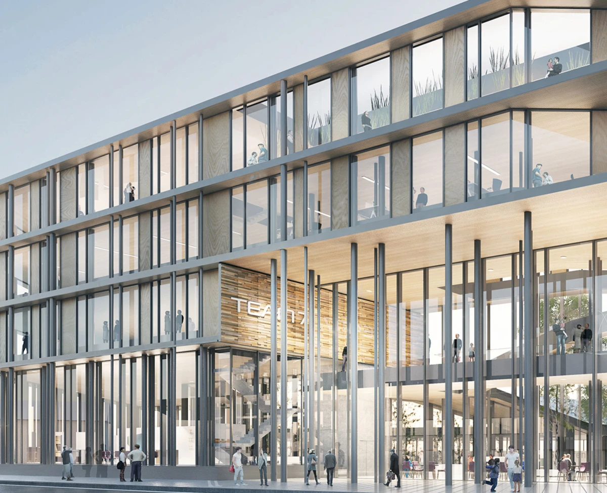 Modern glass-fronted office building with people walking on multiple floors and a bright lobby visible through tall glass walls.
