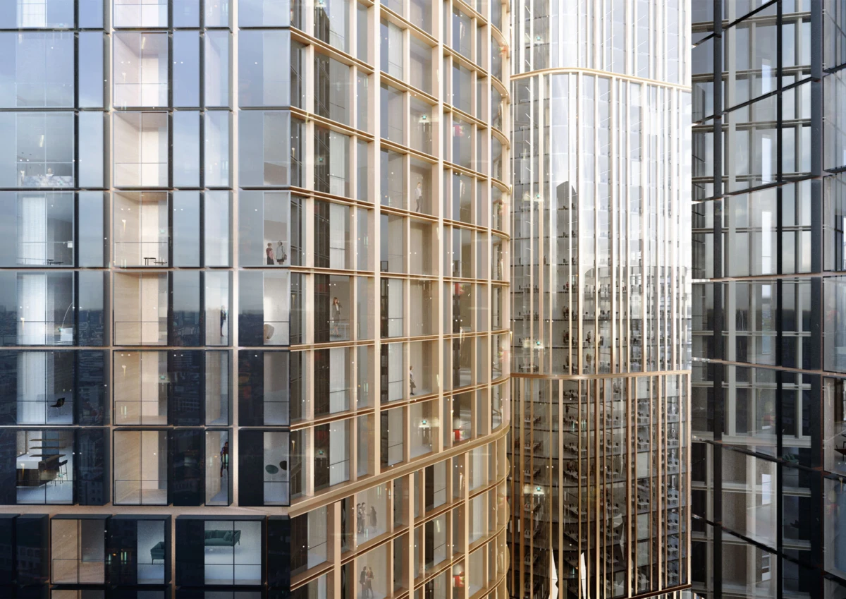 Glass-clad skyscrapers with curved golden frames; interior offices visible through windows in a dense urban skyline.