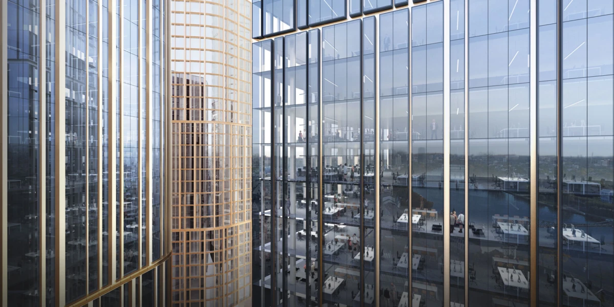 Interior of a modern glass-fronted office tower with gold vertical beams; workers at desks visible through the façade.