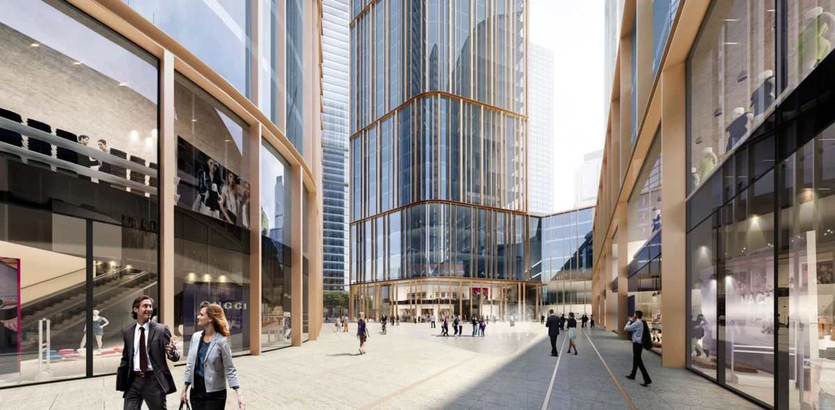 Central urban plaza framed by glass skyscrapers; businesspeople walk and talk near storefronts in a sunlit city center.
