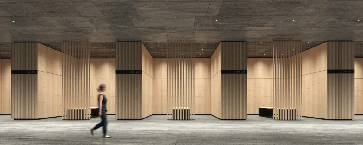Motion-blurred person walking through a spacious wood-paneled interior with vertical slat partitions and benches.