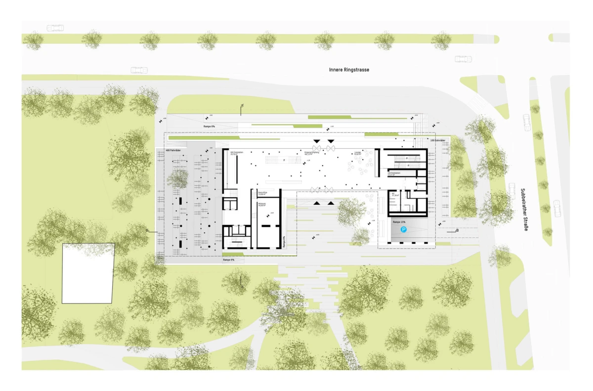 Architectural site plan of a rectangular building complex on a landscaped site with trees, pathways, and adjacent streets.