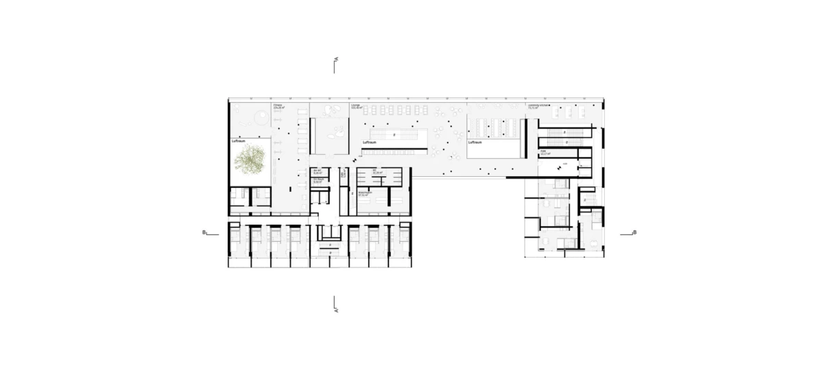 Top-down architectural floor plan of a building interior showing rooms, corridors, and stairwells.