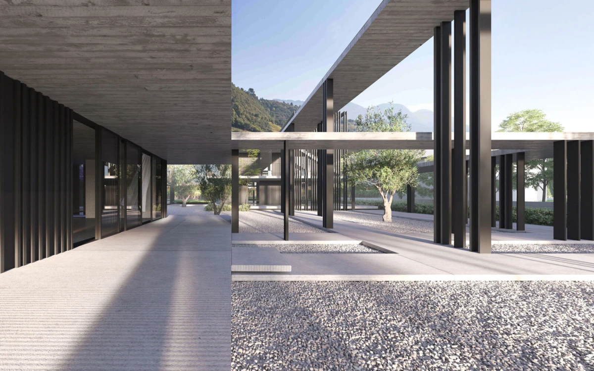 Empty modern architectural courtyard with dark steel columns, glass walls, and gravel plaza; trees and distant mountains in view.