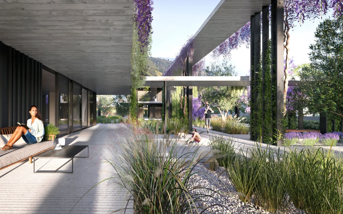 Woman reading a book on an outdoor sofa in a modern courtyard with hanging purple vines and glass walls.