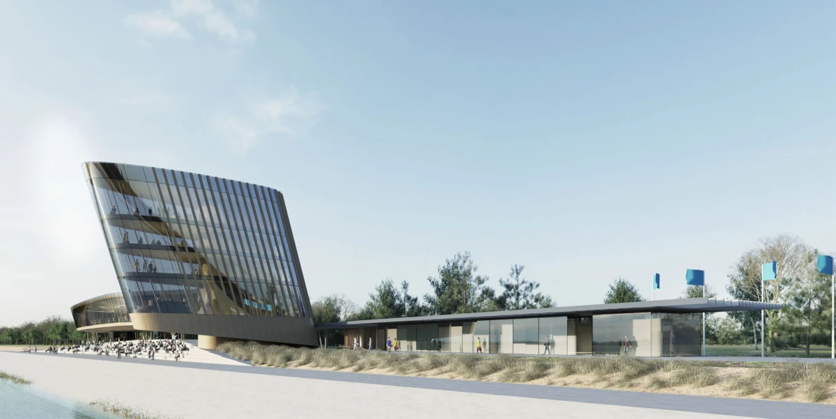 Modern glass-clad museum with a slanted tower and low annex beside a riverside promenade; pedestrians walking.