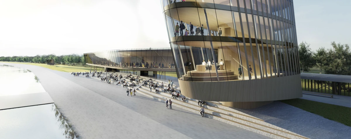 Curved glass-clad modern building beside a waterfront promenade; people sit on steps and stroll along the path.