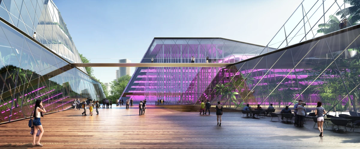 Contemporary glass-walled plaza with a wooden deck; pedestrians stroll toward a pink-purple-lit central glass building and elevated walkway.